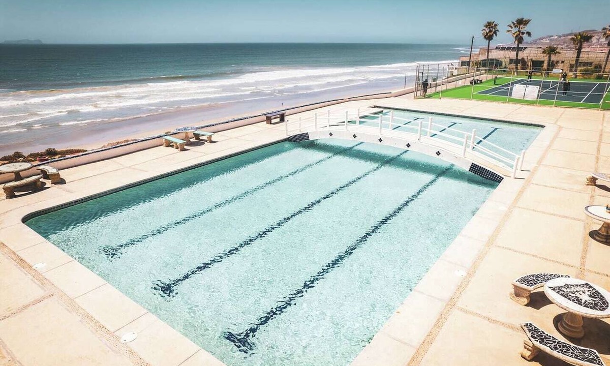 San Antonio del Mar Apartment | Cozy studio 3 blocks from the beach in San Antonio del Mar. Enjoy a private rooftop terrace with our signature galactic whale mural, community pools & tennis courts, and a secure 24/7 gated community. Perfect for couples or small groups.